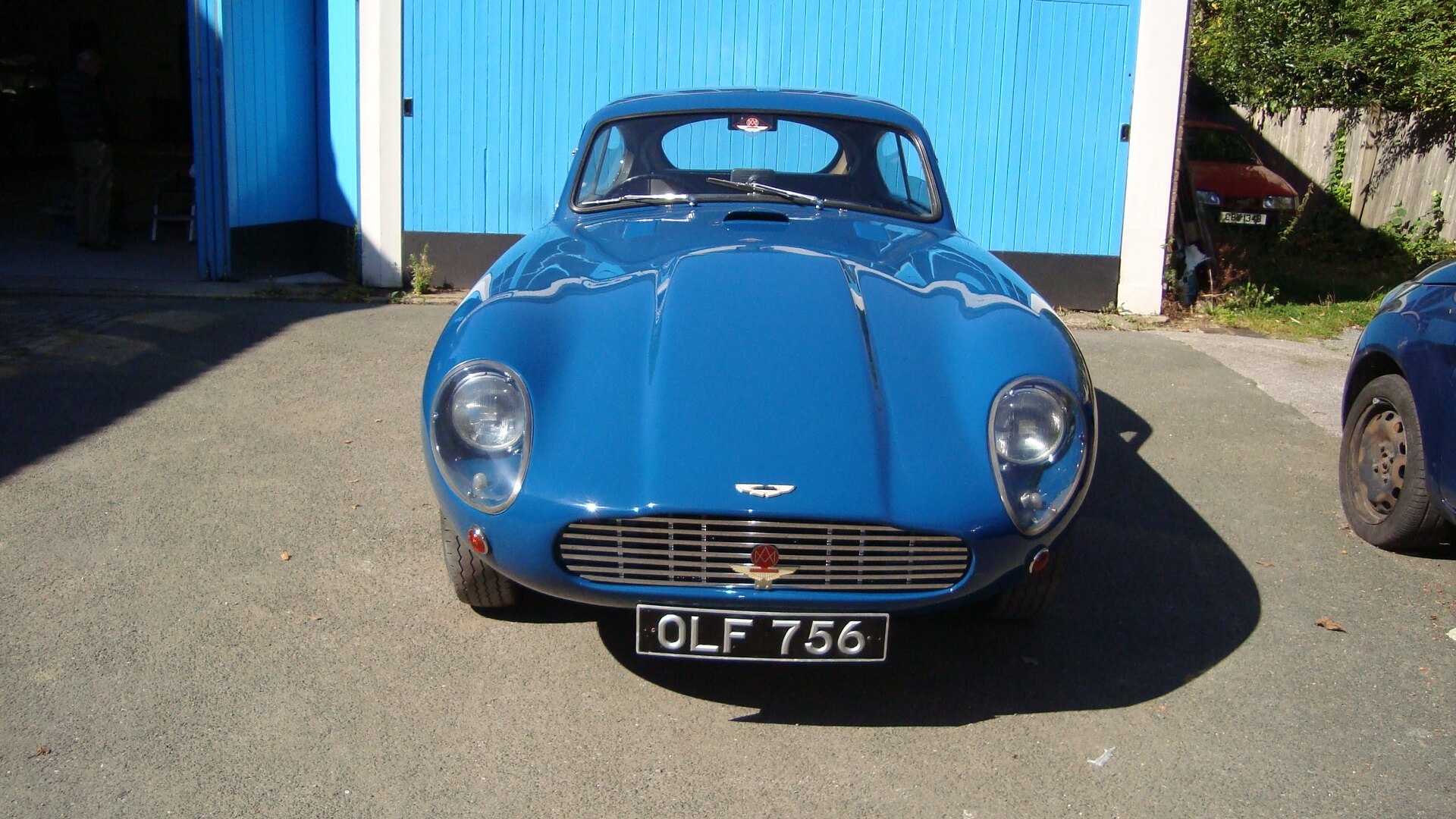 blue aston martin front view